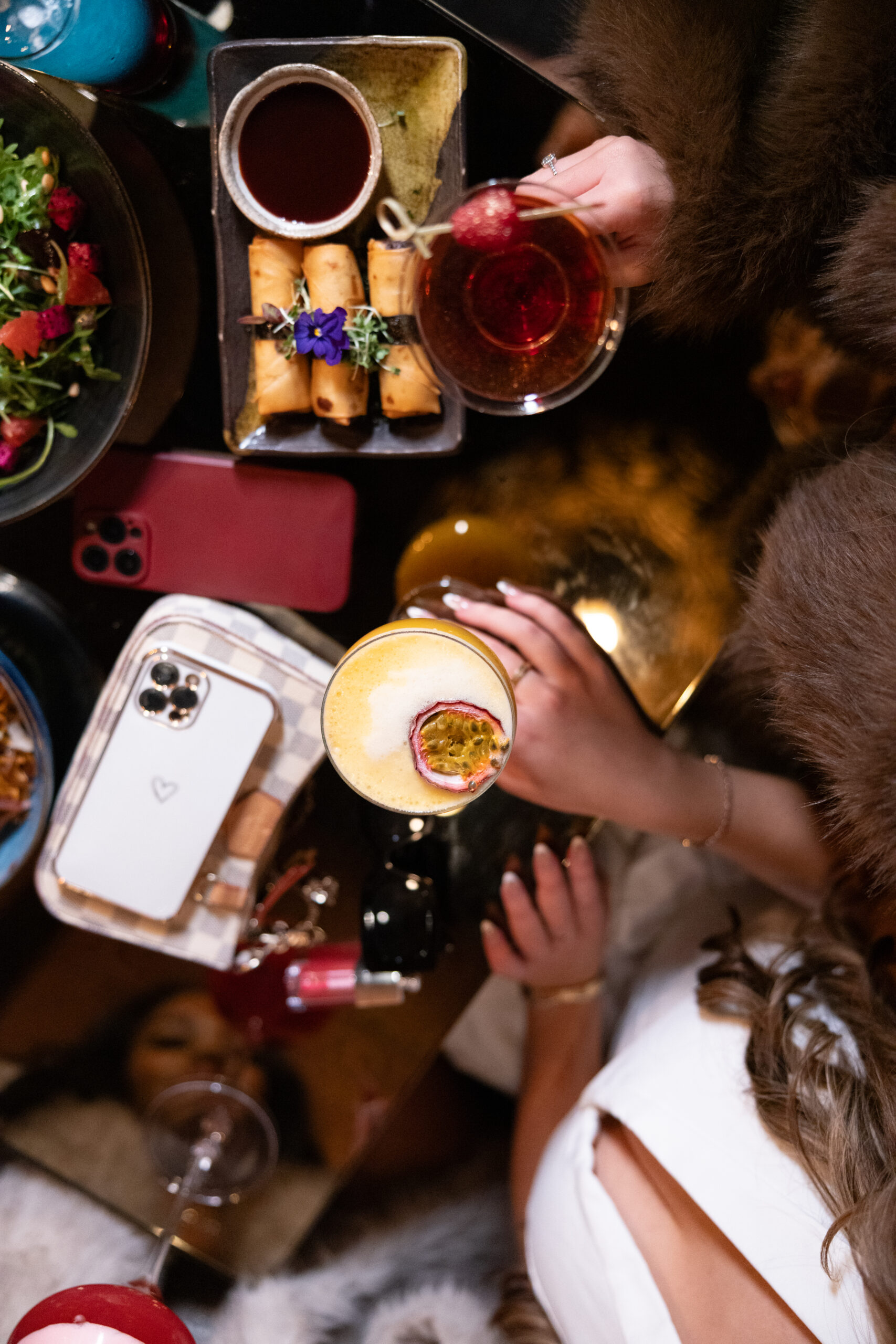 Friends sharing brunch plates and cocktails at Lulu Wild, Birmingham