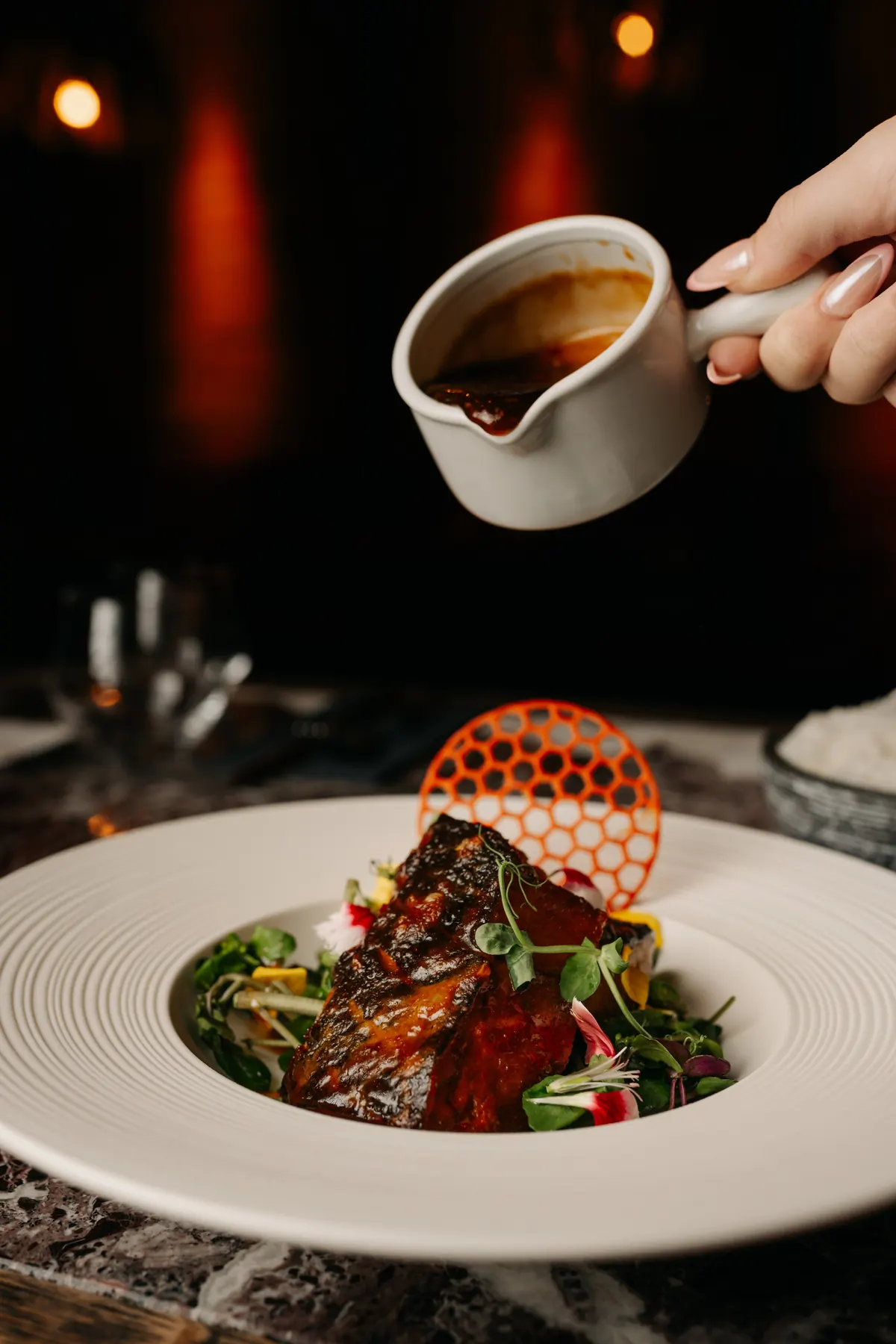 A signature main, finished at the table - the kind of theatre that makes a festive meal feel special.