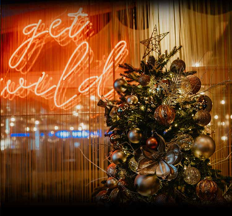 Christmas tree in front of Get Wild sign at Lulu Wild Birmingham Restaurant